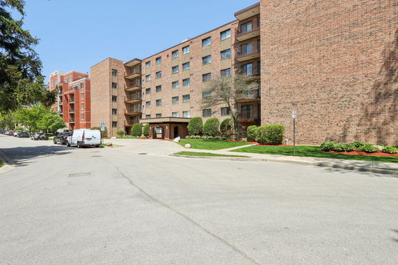 Front view of a multi-story brick apartment building.