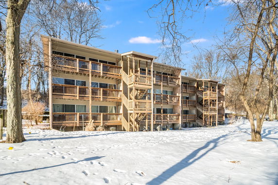 Front view of a multi-story building with exterior staircases and balconies.