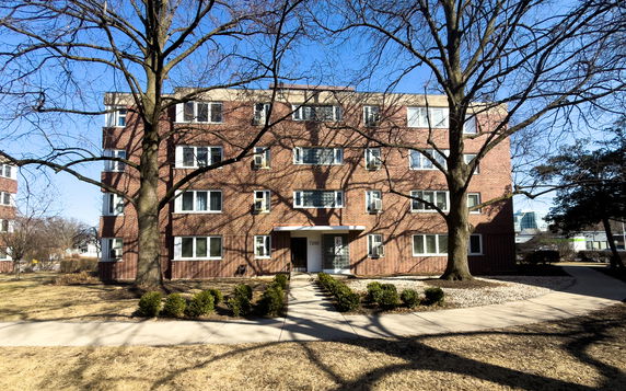 Front view of a multi-story brick apartment building.