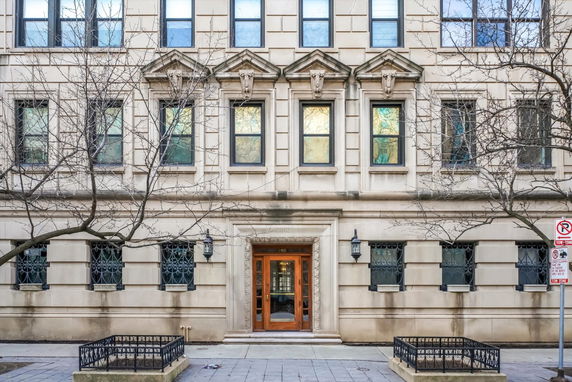 Front view of a multi-story building with decorative architectural elements and large windows.