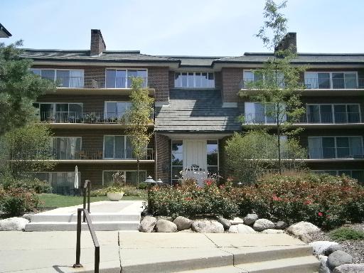 Front view of a multi-story apartment building with balconies.