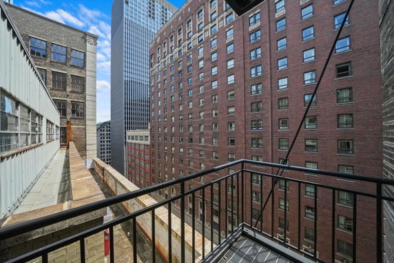 View of tall buildings from a balcony in an urban setting