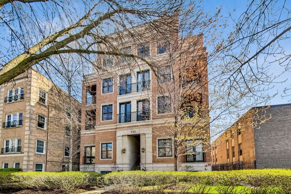 Front view of a multi-story brick apartment building.