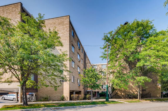 Front view of a multi-story building with brick exterior.
