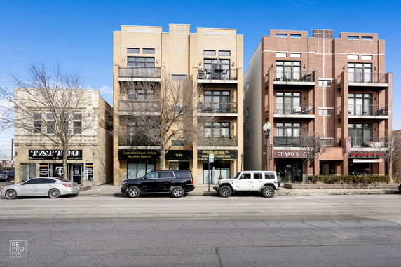 Front view of a row of multi-story commercial buildings with balconies.