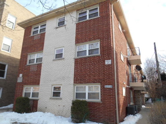 Front view of a three-story brick apartment building.
