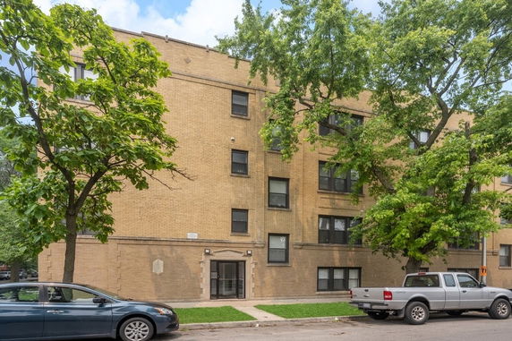 Front view of a multi-story brick apartment building.