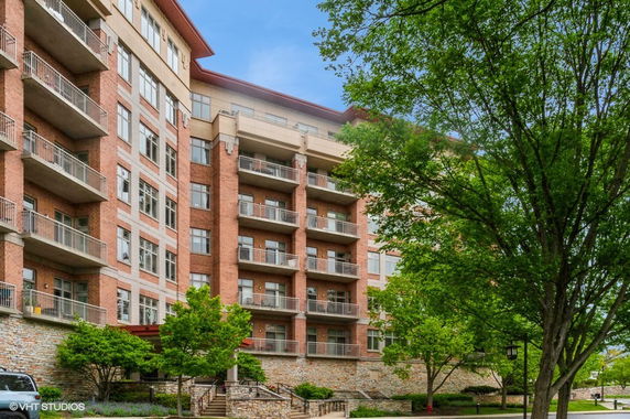 Front view of a multi-story apartment building with balconies.