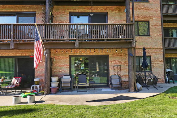 Front view of a brick apartment building with balconies.