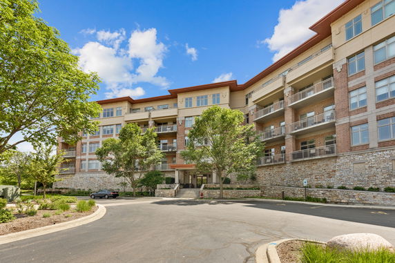 Front view of a multi-story residential building with balconies.