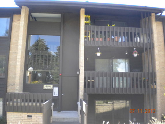 Front view of a multi-story building with balconies.