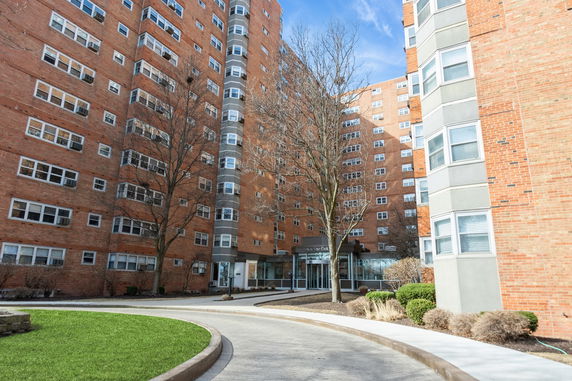 Front view of a multi-story brick apartment building.