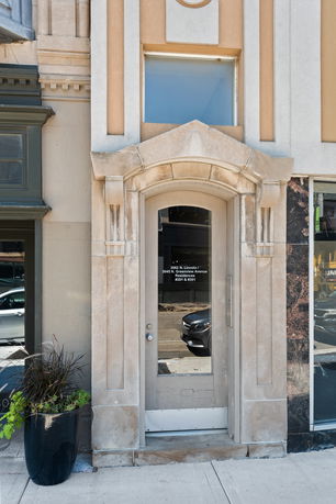 Front view of a building entrance with an arched doorway.