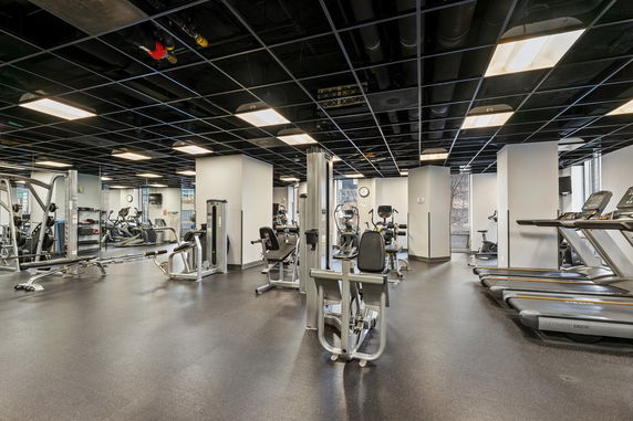 Interior view of a gym with various exercise equipment.