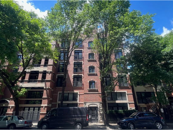 Front view of a multi-story brick apartment building.