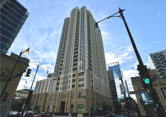 Front view of a tall, multi-story building in an urban setting.