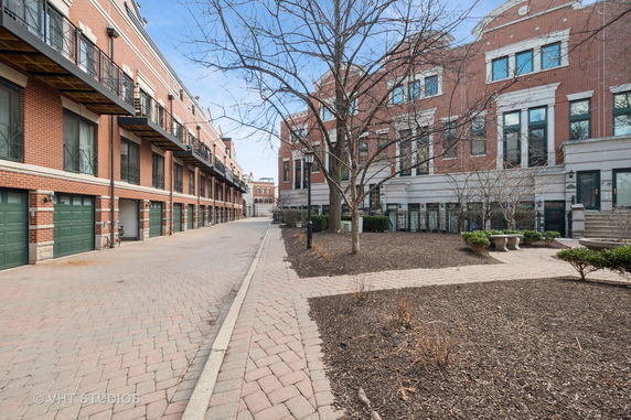 Front view of a brick townhouse complex with multiple floors and balconies.