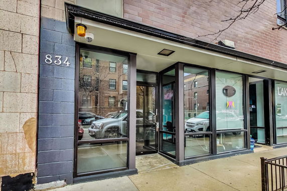 Front view of a commercial building with large windows and a glass door.
