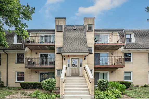 Front view of a multi-story residential building with balconies.
