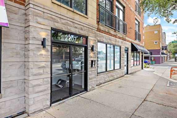 Front view of a commercial building with glass doors and windows.
