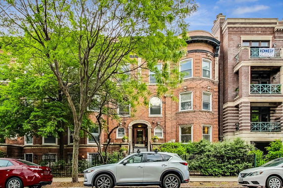 Front view of a multi-story brick apartment building.