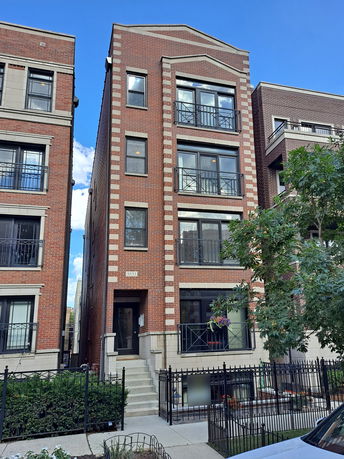 Front view of a multi-story brick building.