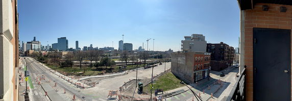 Panoramic view of a cityscape with construction and high-rise buildings.
