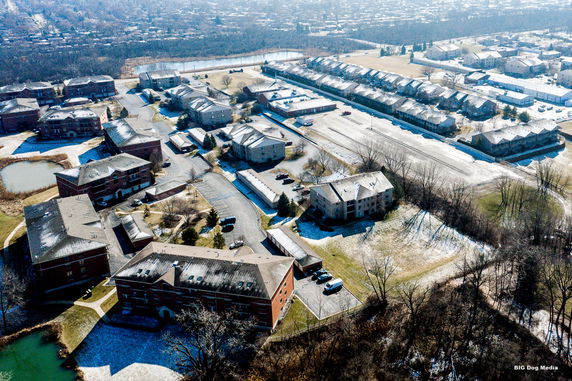 Panoramic aerial view of a residential complex with multiple buildings and surrounding area.