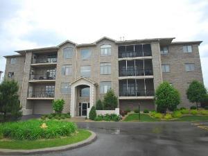 Front view of a multi-story apartment building with balconies.