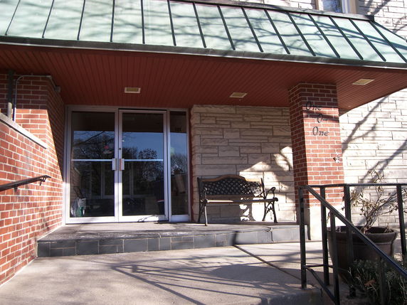 Front view of a building entrance with brick and stone exterior.