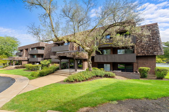 Front view of a multi-story building with wooden exterior accents.