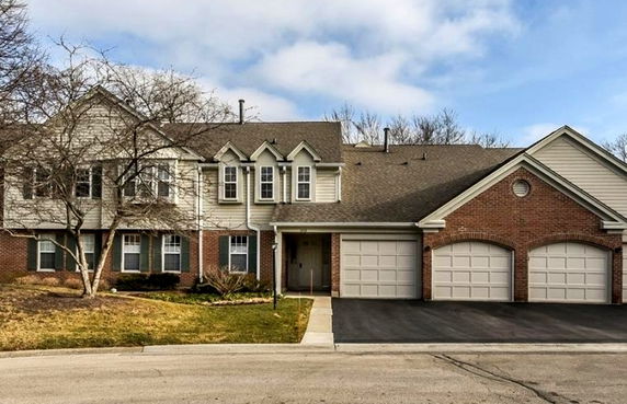 Front view of a two-story house with a triple garage.