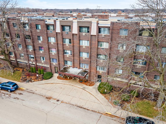 Front view of a multi-story brick apartment building.