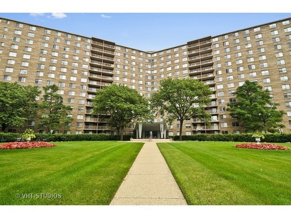 Front view of a large multi-story apartment building.