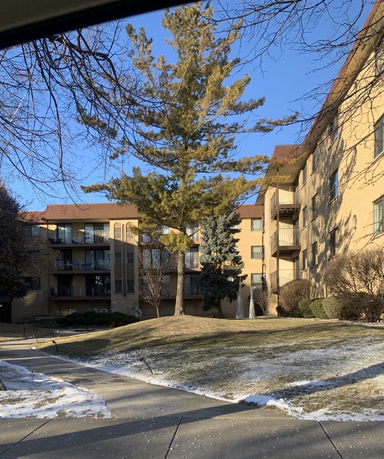 Front view of a multi-story apartment building with balconies.