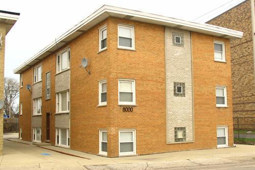 Front view of a two-story brick apartment building.