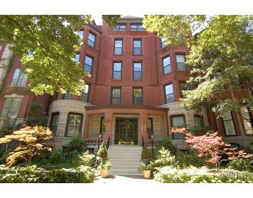 Front view of a multi-story brick building with large windows.