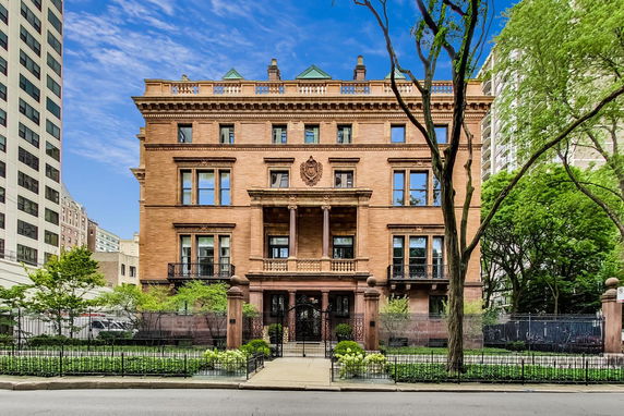 Front view of a historic multi-story brick building with ornate architectural details.