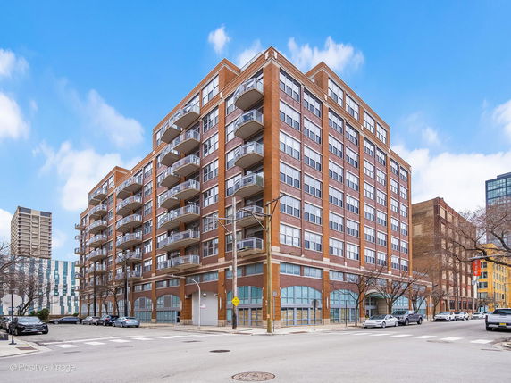 Front view of a multi-story apartment building with balconies.