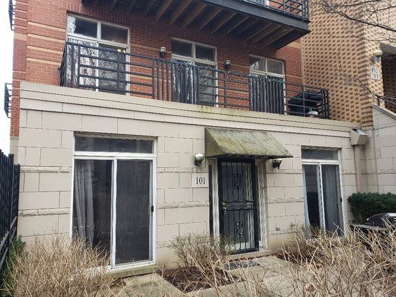Front view of a multi-story residential building with balconies.