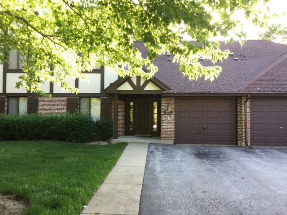 Front view of a house with a double garage and brick exterior.