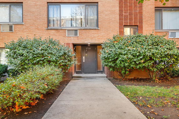 Front view of a brick apartment building entrance.