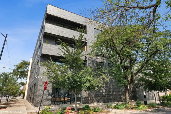 Front view of a multi-story building with a modern brick facade.