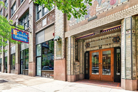 Front view of a building with decorative brickwork and a sign reading 'Franklin Building.'