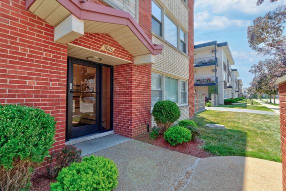 Front view of a brick apartment building entrance.