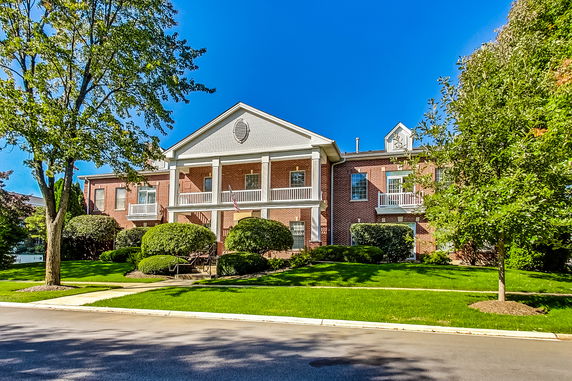 Front view of a two-story brick building with columns.