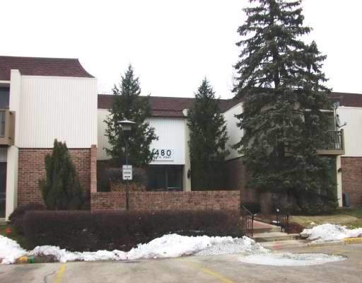 Front view of a two-story building with brick and panel siding.