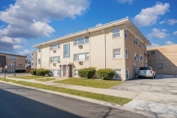 Front view of a two-story brick apartment building.