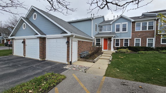 Front view of a two-story house with a double garage.