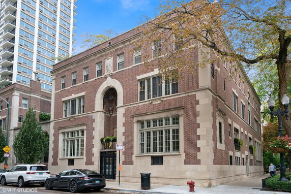Front view of a multi-story brick building with decorative facade.